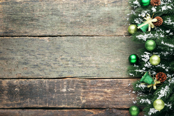 istock Christmas fir-tree branches with baubles and cones on wooden table 993618546