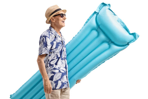 istock Elderly tourist holding an air mattress 993622920
