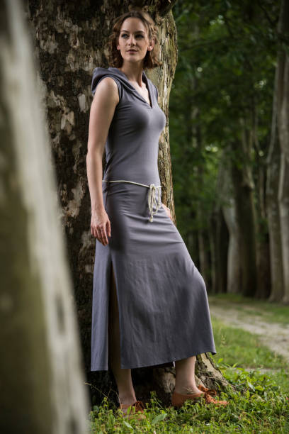istock Lovely beautiful young model posing in the nature, with trees on background. 993627242