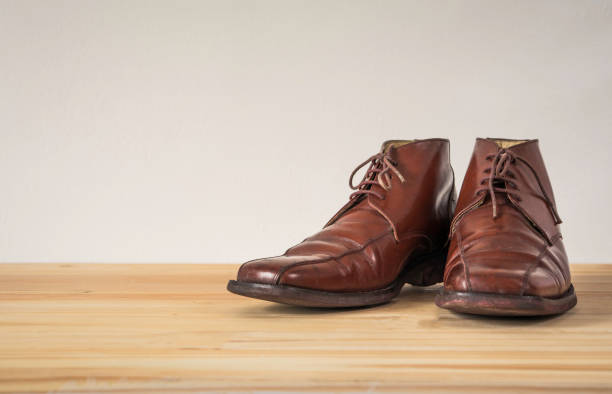 istock Brown leather boots on wooden floor 993630136