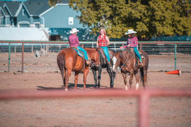 istock Young cowgirls riding horses on a ranch 993630586