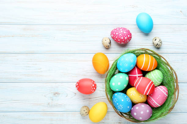 istock Colorful easter eggs in basket on wooden table 993631002