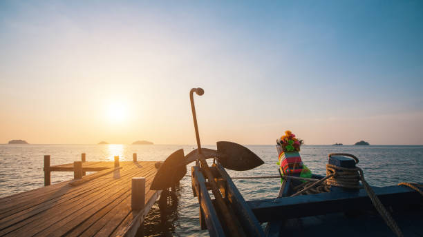 Wooden fishing boat near the pier during sunset. Wooden fishing boat near the pier during sunset. kep stock pictures, royalty-free photos & images