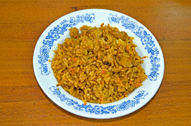 istock Plate with plov on the table. Asian cuisine. Cooking at home 993639470