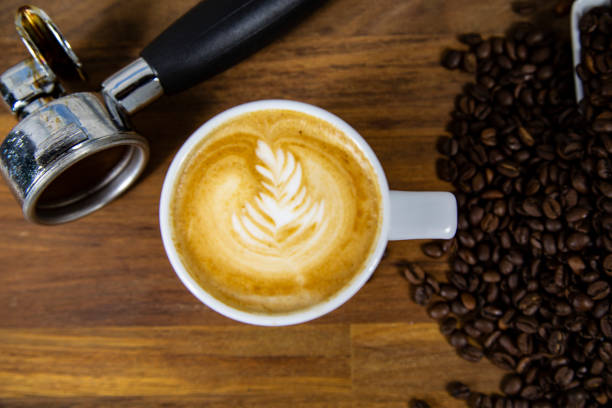 istock Coffee cup latte art with coffee beans 993639540
