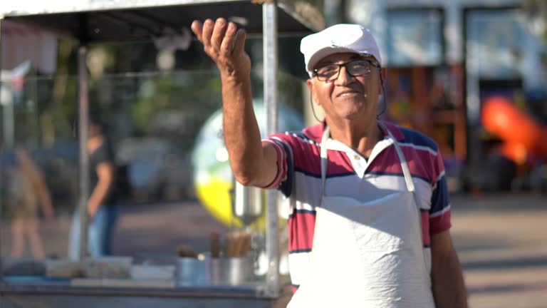 Mature Man inviting people to come to your churros store