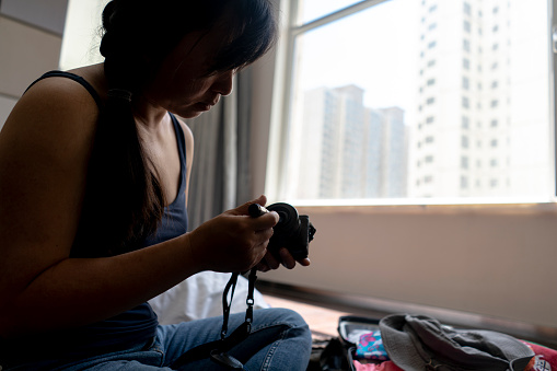 girl cleaning camera before travel