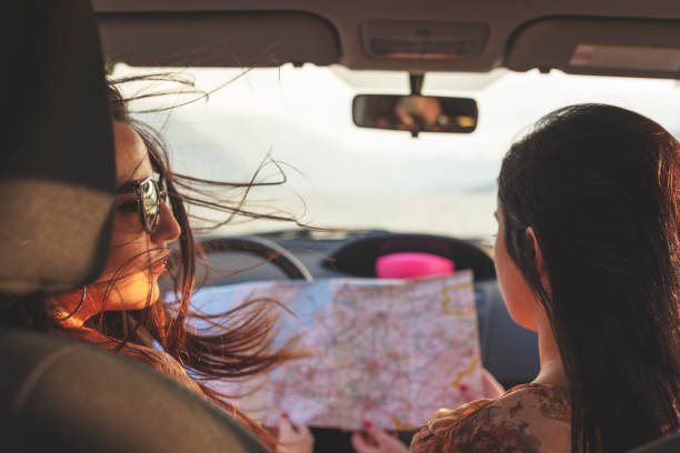 istock Women with road map in the car 993653798