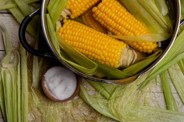 istock Sweet corn boil with salt. cooked sweet corn in pot on wooden table. 993667108