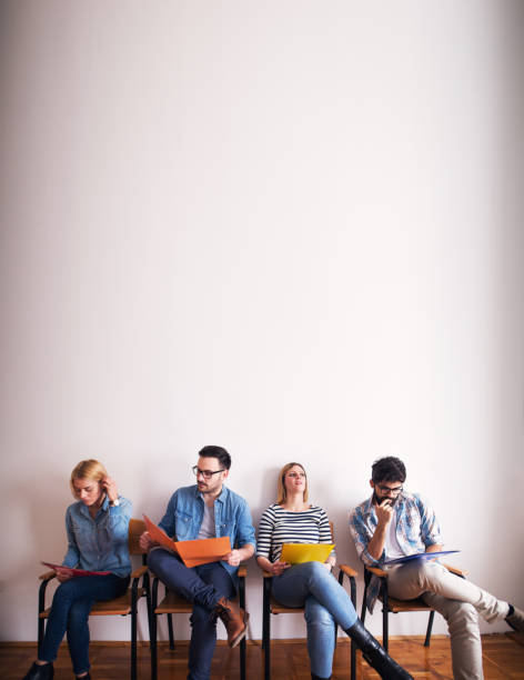 istock Several young job applicants are waiting impatiently to be called in while going through their scripts. 993667296