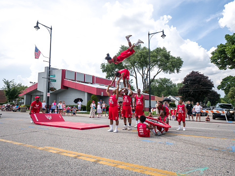 Morton Grove, IL - July 4th 2018: The Jesse White Tumbling Team entertains the crowds with their acrobatic jumps on the annual Morton Grove Fourth of July parade route Wednesday afternoon.
