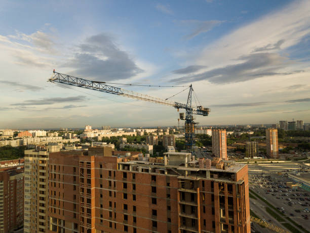 istock Aerial view of a new modern house under construction with a blue tower crane 993668450