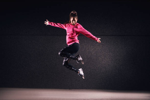 istock Fit athletic girl in mid-air expressionism. 993672540