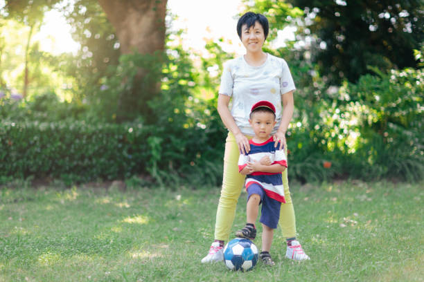 istock Mother and son with soccer ball posing for camera 993676806