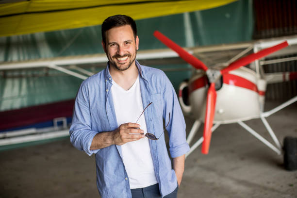 istock Young man in the airplane hangar 993680122