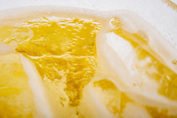 istock Pouring beer with bubble froth in glass for background 993687750
