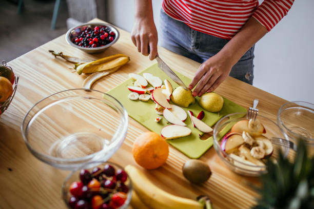 istock Girl preparing fruit salad 993691364