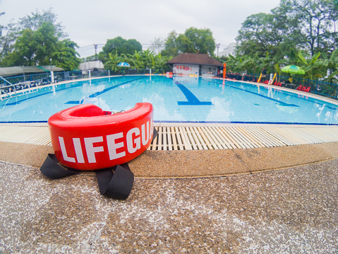 pool lifeguards red rescue tube near swimming pool