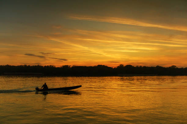 istock Lonely fisherman in romantic sunset 993705532