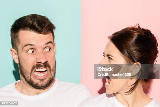 Attractive Angry Couple Fighting And Shouting At Each Other Stock Photo - Download Image Now