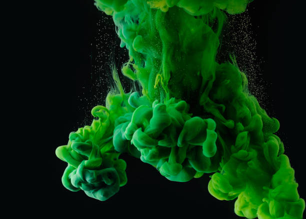 istock close-up view of green abstract ink explosion on black background 993706584
