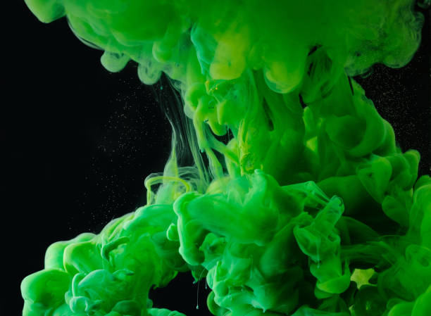 istock close-up view of green abstract flowing paint on black background 993706708