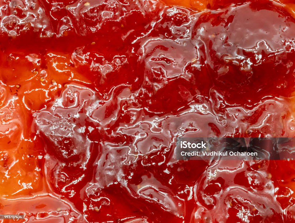 close up of red strawberry jam for texture and background Preserves Stock Photo