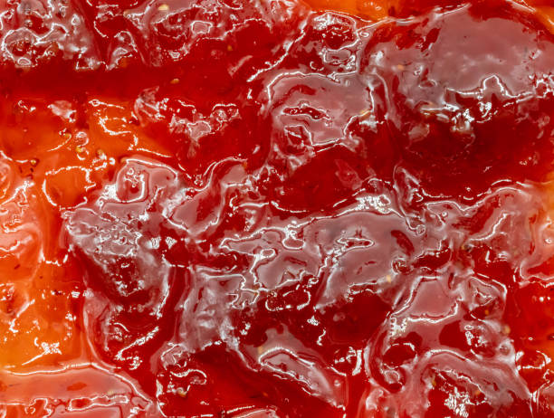 close up of red strawberry jam for texture and background stock photo
