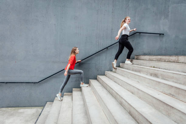 Friends walking on stairs by concrete wall