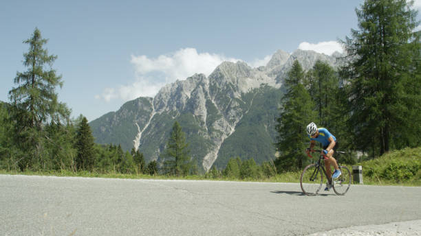 istock Gritty mountain biker pedaling up a steep mountain on a sunny summer afternoon. 993718504