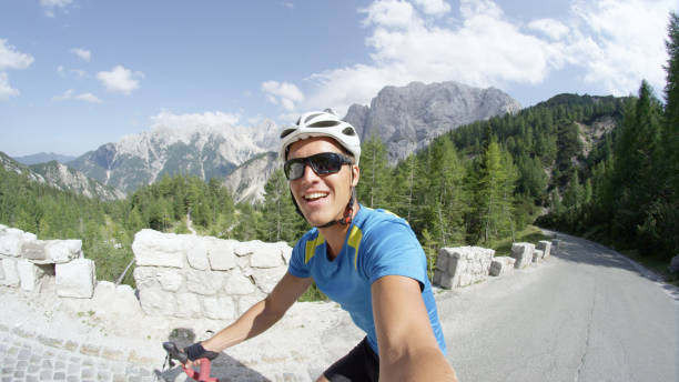 istock SELFIE: Athletic man laughs while he pedals uphill in the picturesque mountains. 993718744
