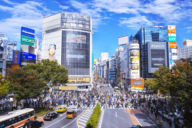 Scenery of scrambled intersection of Shibuya Tokyo, Japan-November 12, 2017: Scenery of scrambled intersection of Shibuya station west exit in Tokyo Shibuya Ward. This scrambled intersection is the biggest and most famous intersection in Japan. A lot of people rush from all directions at once. shibuya district stock pictures, royalty-free photos & images