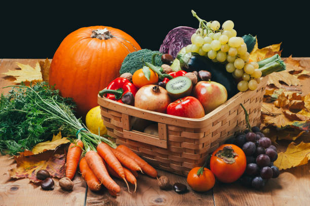 istock Autumn fruits and vegetables on rustic wooden table 993722892