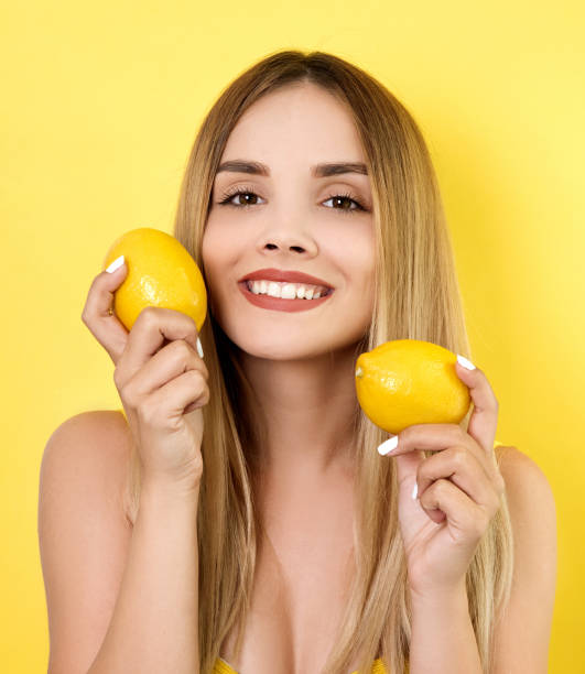istock Young woman holding lemons 993724664