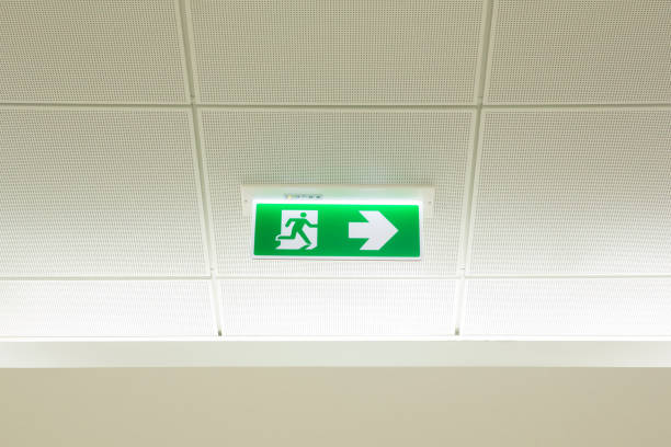 istock Green emergency exit sign showing the way to escape.Fire exit in the building. 993733228