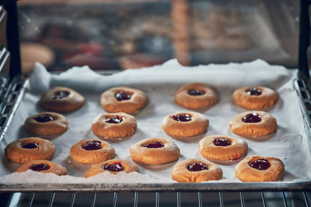 istock Preparing Peanut Butter Cookies with Marmalade in Domestic Kitchen 993733280