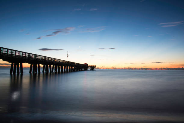 istock Pompano Beach Pier at sunrise with sun and Golden Clouds 993734122