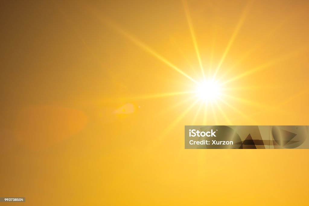 Hot summer or heat wave background, orange sky with glowing sun Summer background, orange sky with glowing sun Sun Stock Photo