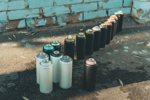 istock cans with aerosol paint standing in row on asphalt 993741146