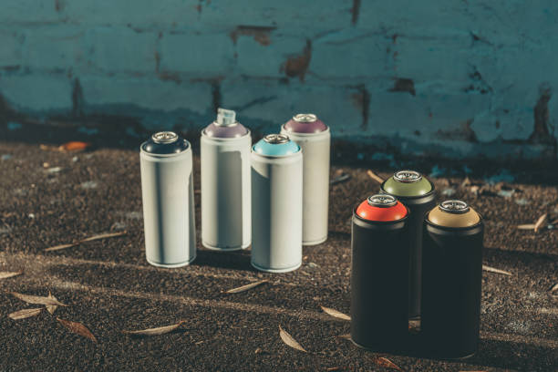 istock cans with colorful spray paint for graffiti on asphalt 993741252