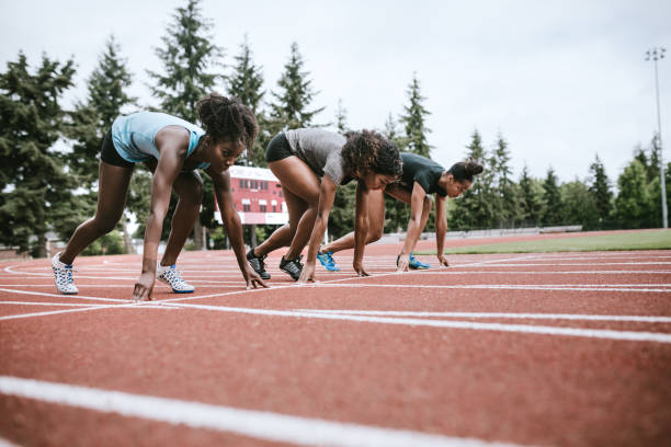 istock Woman Athletes At Race Starting Line Ready to Run 993744396