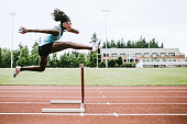 istock Woman Athlete Runs Hurdles for Track and Field 993744768