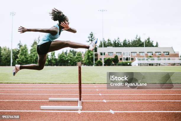 Woman Athlete Runs Hurdles For Track And Field Stock Photo - Download Image Now - Athlete, Sport, Hurdle