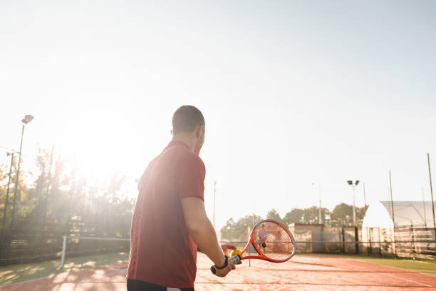 istock Young man is playing tennis on fresh sunny morning 993748526