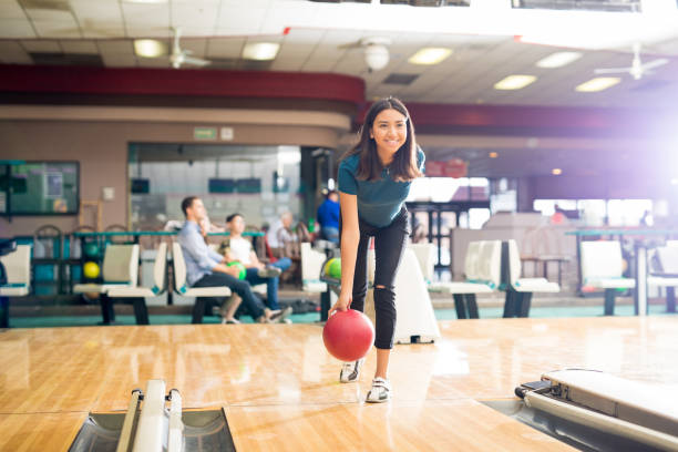 adolescente, lanzando la bola mientras que la formación de bolos - bowling holding bowling ball hobbies fotografías e imágenes de stock