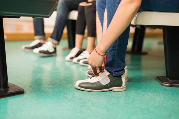 istock Low Section Of Boy Wearing Bowling Shoe 993764064