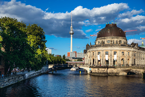 Berlin, Germany - June 30, 2018: Berlin cityscape view from a downtown bridge on Spree river, museum island with TV tower in the background.