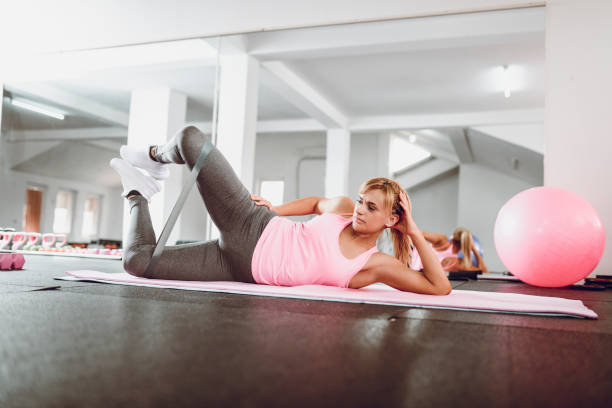 istock Female Athlete Working Out With Rubber Band In Gym 993769948