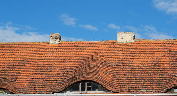 istock Red tiled roof with attic windows 993770900