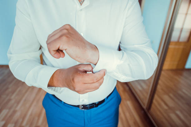 istock businessman puts on a shirt.businessman dressed for work 993776722